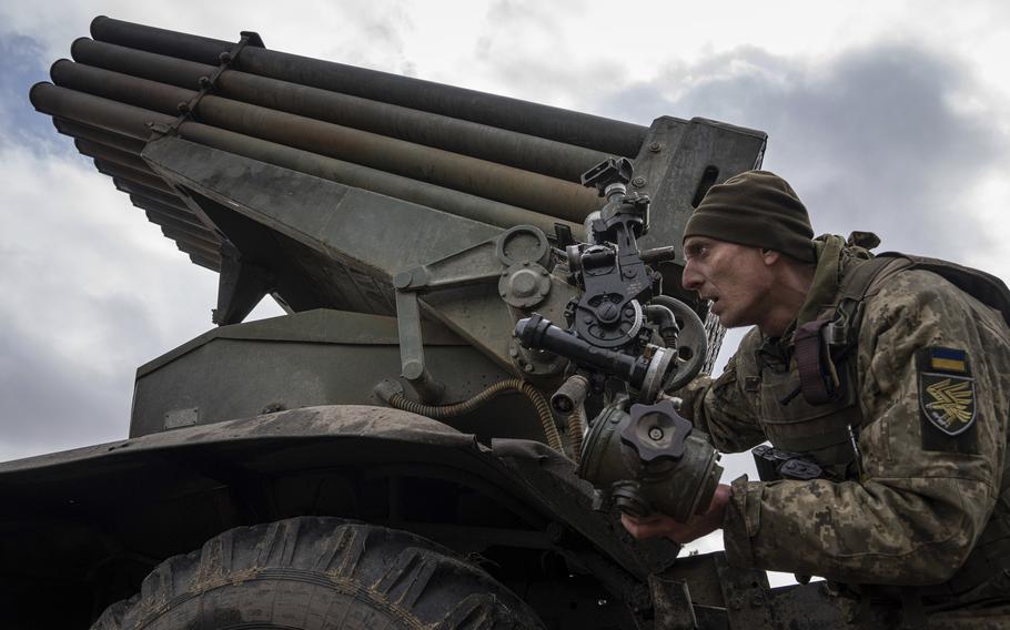 A Ukrainian paratrooper of 95 Air Assault brigade aims an MSLR BM-21 “Grad” toward Russian positions at the frontline near Kreminna, Ukraine, Thursday, March 9, 2023.