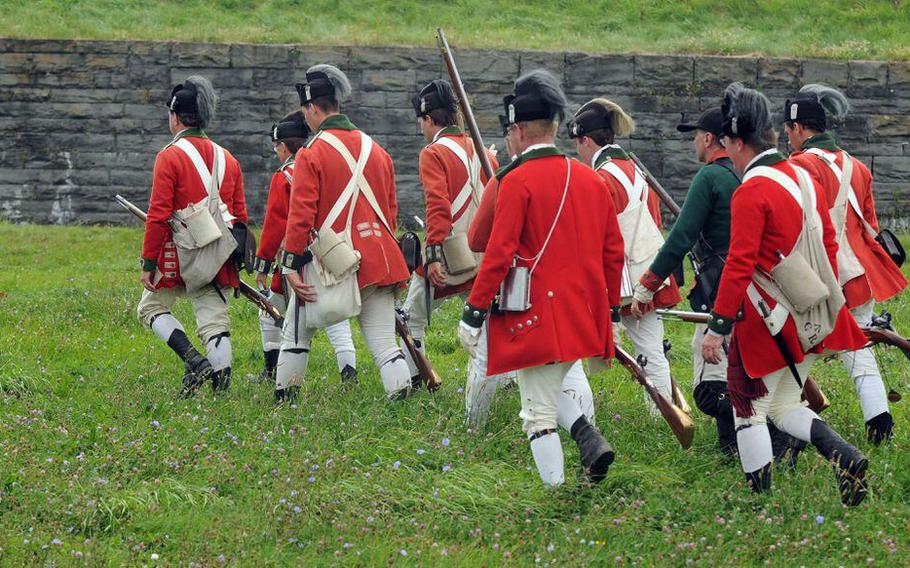 A group of reenactors, playing British soldiers, march back to Fort Ontario during a reenactment at the fort. The doomed campaign to recapture it in the winter of 1783 was the final campaign of the American Revolution.    