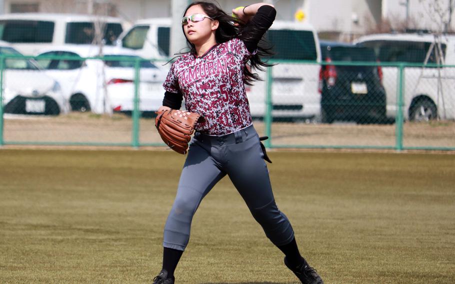 Jillian Javier throws the ball to the infield.