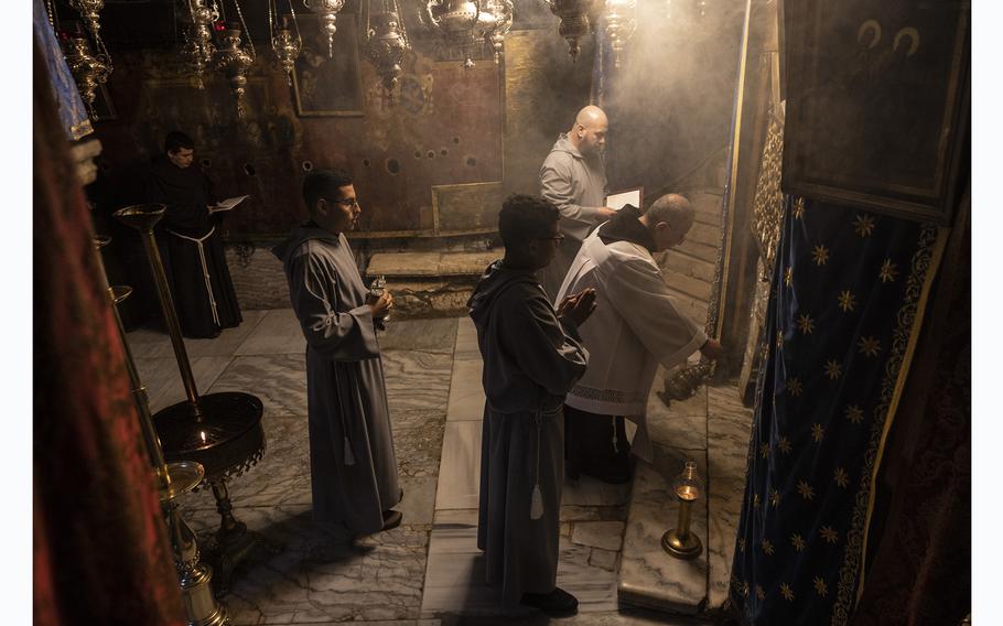 Catholic clerics perform a service Dec. 21, 2023, in the grotto of the Church of Nativity, by tradition the birthplace of Jesus. 