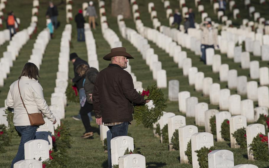 Tens of thousands of volunteers helped place more than a quarter-million wreaths at Arlington National Cemetery on Saturday, Dec. 17, 2022.