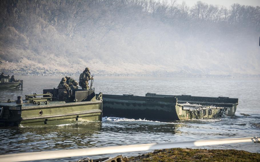 U.S. Army soldiers of the 11th Engineer Battalion, 2nd Infantry Division, and South Korean troops of the 5th Engineer Brigade move bridge parts during wet gap training at the Imjin River, South Korea, March 20, 2024. 
