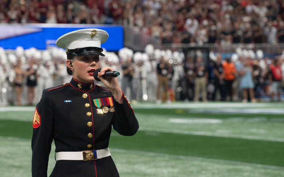 A Marine performs the national anthem.