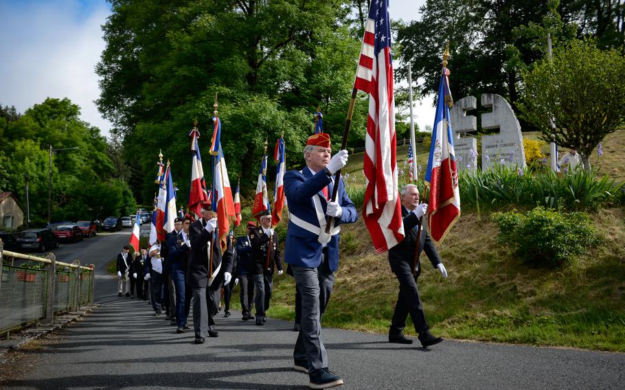At front left, retired U.S. Marine Corps Col. Jim Jamison leads a flag honor guard formation for a ceremony commemorating fallen resistance fighters and U.S. special operators killed during World War II, in Le Rialet, France, May 28, 2022. Jamison accompanied his wife Jamie, who is the grand niece of an Office of Strategic Services member killed while fighting German troops.
