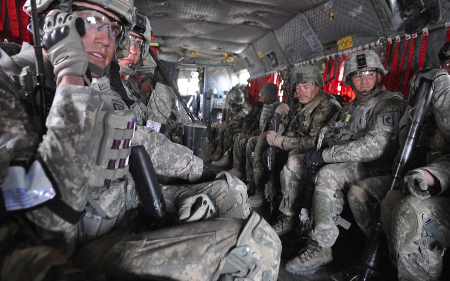 Soldiers of B Company, 173rd Airborne Brigade Combat Team ride a Chinook helicopter to a mission in the town of Khanjankhel, in Wardak province.