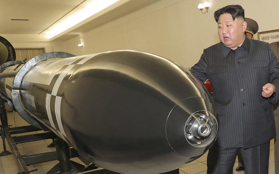 In this photo provided on Tuesday, March 28, 2023, by the North Korean government, North Korean leader Kim Jong Un visits a hall of what appeared to be various types of warheads designed to be mounted on missiles or rocket launchers on March 27, 2023, in an undisclosed location in North Korea.