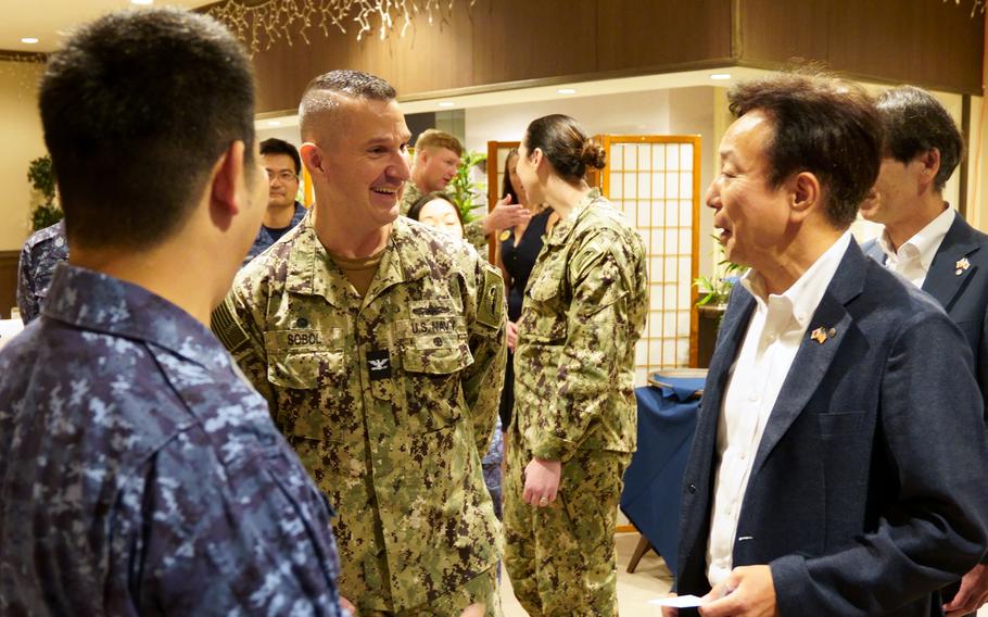 Capt. Les Sobol, commander of Yokosuka Naval Base, Japan, chats with a Yokosuka city official ahead of a curry-tasting event at Club Alliance, July 21, 2023. 