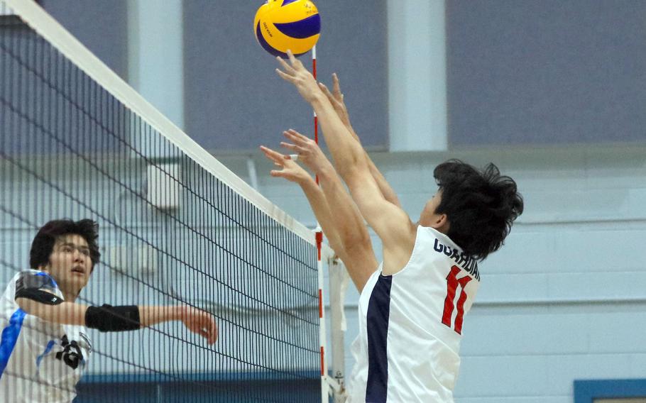 Osan's Ben Plouff spikes against Yongsan International-Seoul's Ashton Shim and Ryan Suh during Saturday's Korea boys volleyball match. The Guardians won in four sets.