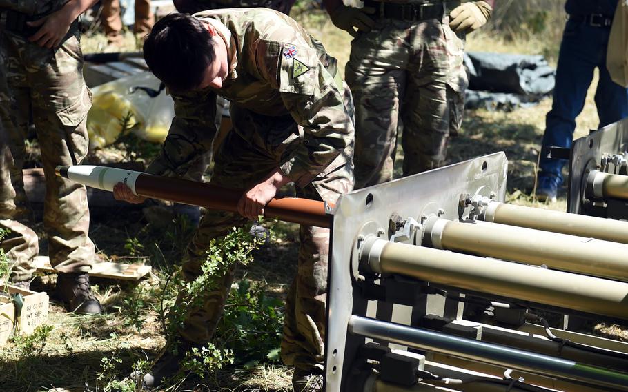 A U.K. soldier from the 26th Regiment Royal Artillery loads practice rockets into M27 Multiple Launch Rocket System canisters during the Dynamic Front exercise, July 20, 2022, at Grafenwoehr Training Area, Germany. 