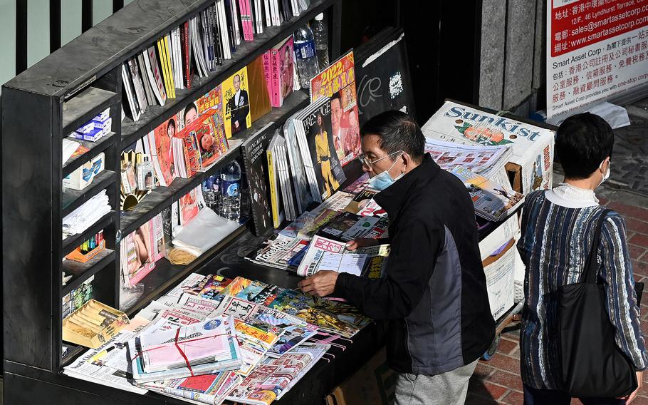 A vendor sorts newspapers at a newsstand in Hong Kong on Jan. 6, 2022. China’s crackdown on dissent has silenced or jailed most Hong Kong democracy activists and has now begun to focus on the press. 