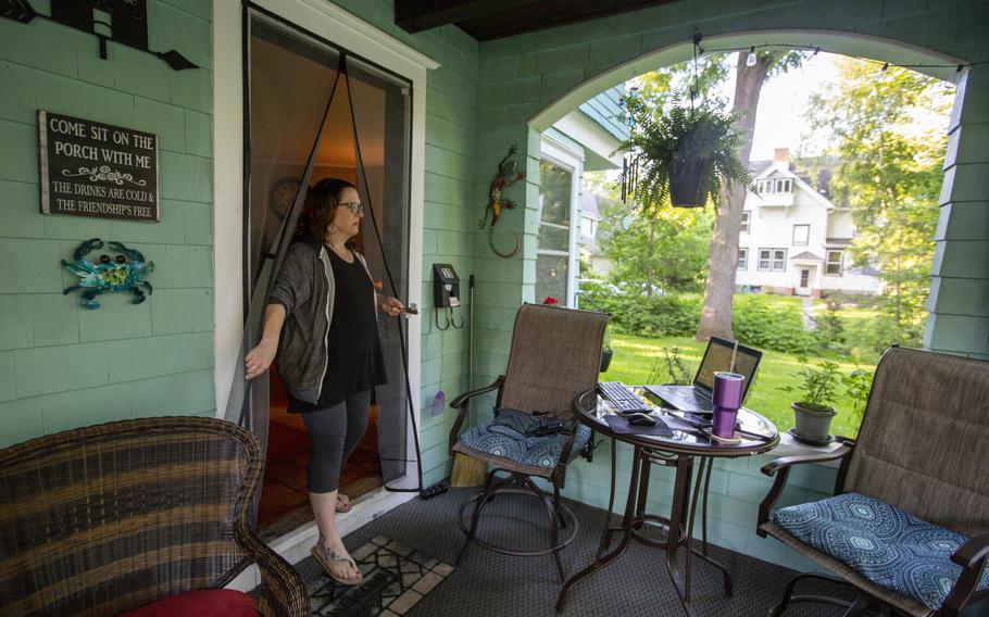 Kim Staffieri at her home in Fairport, N.Y., on June 13, 2022. Staffieri begins her day by setting up a workstation on her front porch, from where she volunteers to help Afghans who assisted the U.S. government during 20 years of war. 