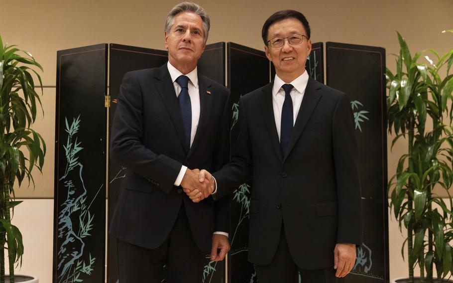 Secretary of State Antony Blinken and Chinese Vice President Han Zheng shake hands while posing for photos, Monday, Sept. 18, 2023, in New York. 