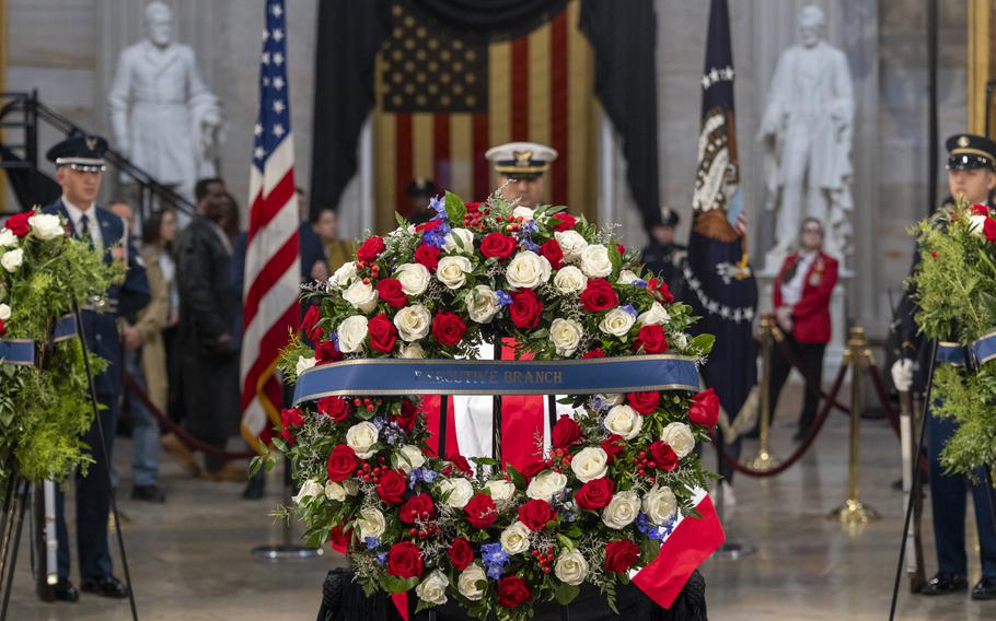 Flowers and casket displayed of former President Jimmy Carter in the Capitol Rotunda. 