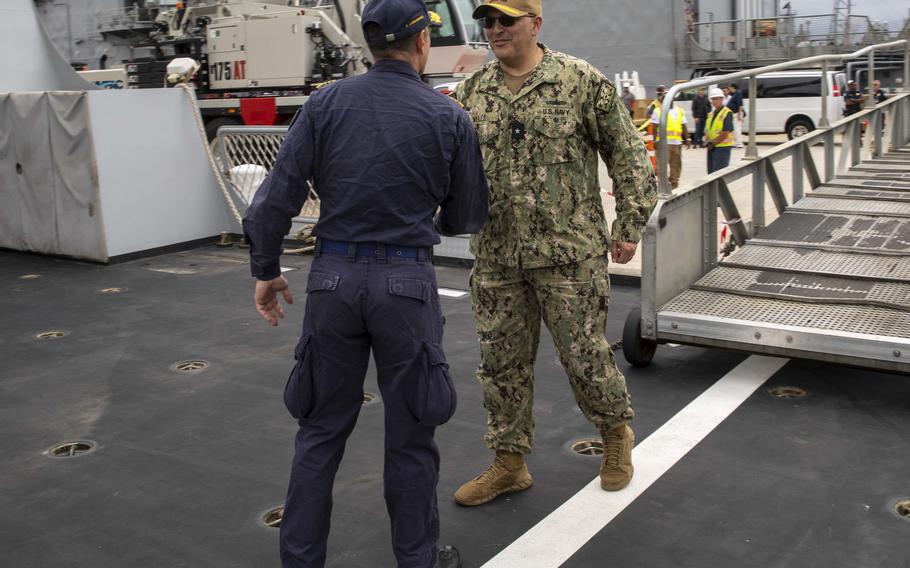 Rear Adm. Dennis Velez, commander, Carrier Strike Group (CSG) 10 and George H.W. Bush CSG, welcomes Italian navy Capt. Jacopo Rollo, commanding officer of the Italian Navy destroyer ITS Caio Duilio (D 554), upon Caio Duilio’s arrival on board Naval Station Norfolk, May 23, 2022.