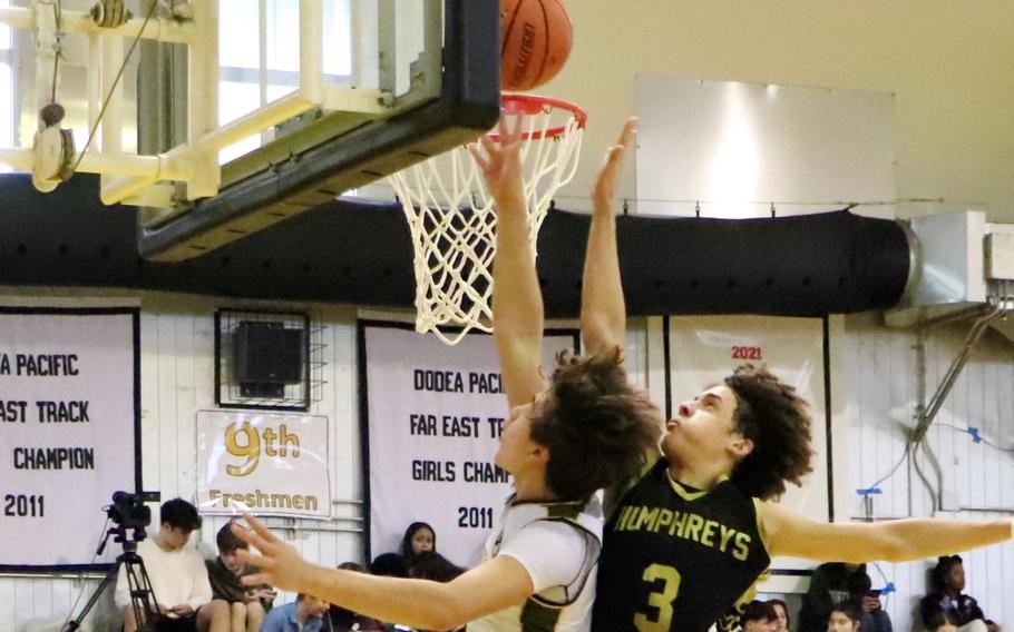 Humphreys' Brandon Howell and ASIJ's Shou Murakami-Moses go up for the ball. The Mustangs won the quarterfinal game 61-48.