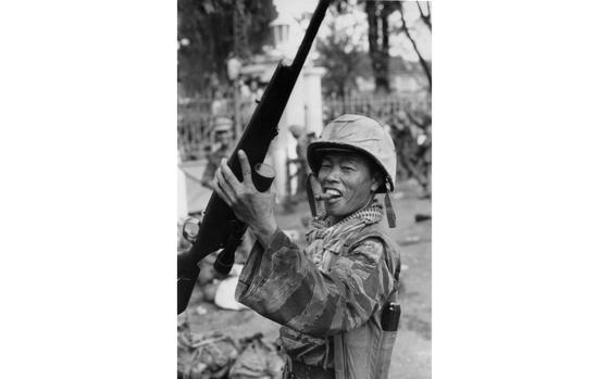 Saigon, South Vietnam, 1963: A Vietnam Marine celebrates on the streets of Saigon after the successful coup deposing president Ngo Dinh Diem November 1, 1963 by a group of Army of the Republic of Vietnam officers. The South Vietnames president and his brother Ngo Dinh Nhu fled the capital through underground tunnels, but were captured and executed the next day.

Looking for Stars and Stripes’ coverage of the Vietnam War? Subscribe to Stars and Stripes’ historic newspaper archive! We have digitized our 1948-1999 European and Pacific editions, as well as several of our WWII editions and made them available online through https://starsandstripes.newspaperarchive.com/

METADATA: Pacific; Vietnam War; war; conflict; weapon; rifle; Vietnamese Marine Corps; Marine; cigar; coup; war trophy
