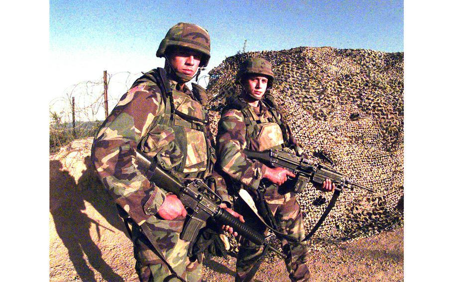 Half brothers down range at Check Point Sapper, July 7, 2000. Pfc. Dan Fareh (left) and Pfc. Jeremy Mathis, with Alpha Company, 16th Engineers Battalion, entered the Army on the “Buddy Program” and elected service in Kosovo together.