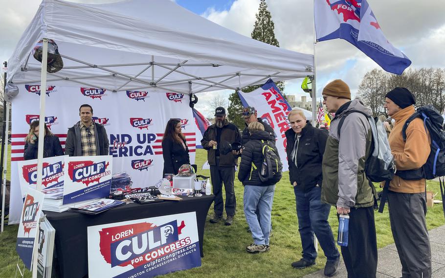 Campaign volunteers for congressional candidate Loren Culp talk to voters in Olympia, Wash., on March 5, 2022. 