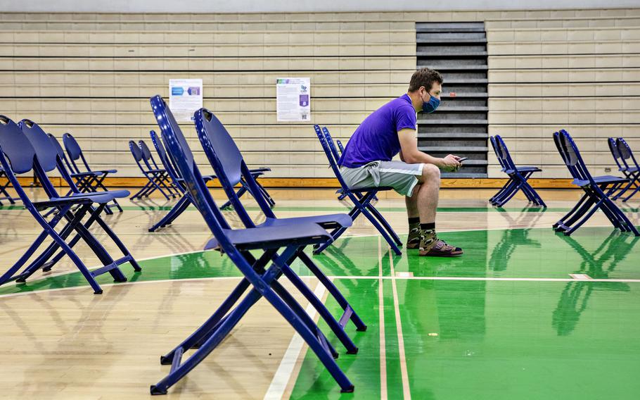 Alex Olsen waits the recommended 15 minutes after receiving a vaccination in Provo, Utah. 