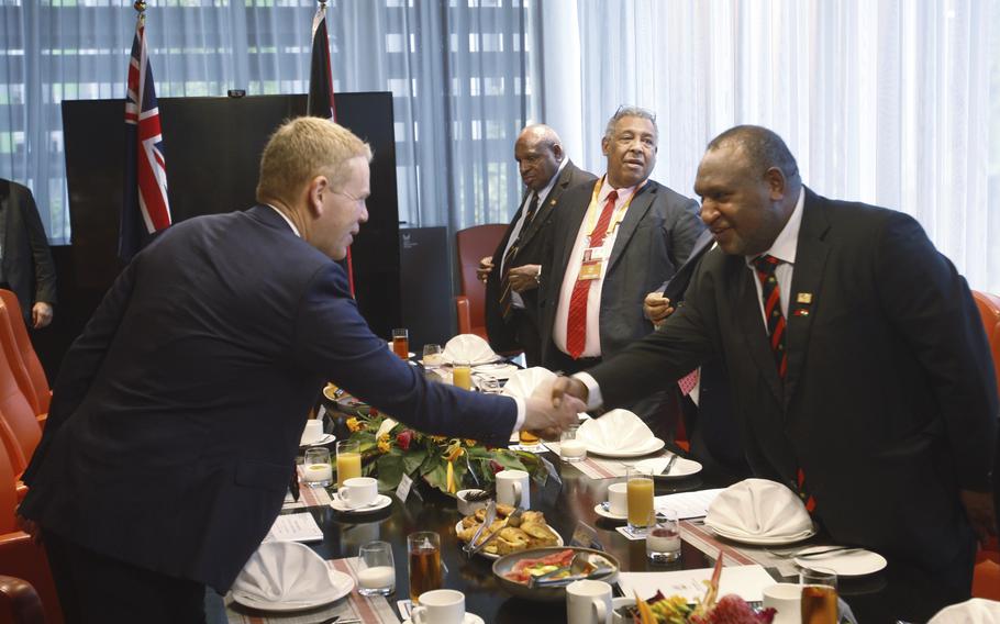 Papua New Guinea Prime Minister James Marape, right, shakes hands with New Zealand Prime Minister Chris Hipkins at a breakfast meeting in Port Moresby, Papua New Guinea, Monday, May 22, 2023. 