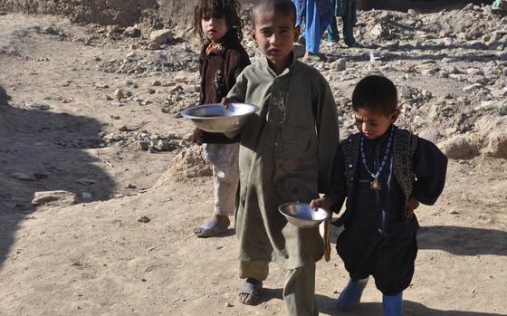 Charah-e-Qambar, Afghanistan, Dec. 13, 2010: Children at the Charah-e-Qambar camp for displaced persons on the outskirts of Kabul clutch lunch distributed by an international aid agency.

RELATED: Afghans displaced by war find refuge and little else in Kabul. https://www.stripes.com/news/afghans-displaced-by-war-find-refuge-and-little-else-in-kabul-1.135016

META TAGS: META TAGS: Operation Enduring Freedom, War on Terror, Afghanistan, Afghan, refugees; 