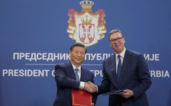 Chinese President Xi Jinping, left, shakes hands with Serbian President Aleksandar Vucic at the Serbia Palace, in Belgrade, Serbia, Wednesday, May 8, 2024. (AP Photo/Darko Vojinovic)