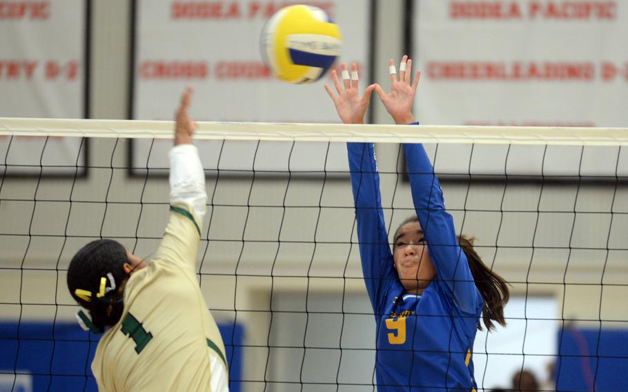 Robert D. Edgren's Zalea Washington spikes against Yokota's Erica Haas during Saturday's DODEA-Japan volleyball match. The Panthers won in five sets, splitting their weekend series with the Eagles.