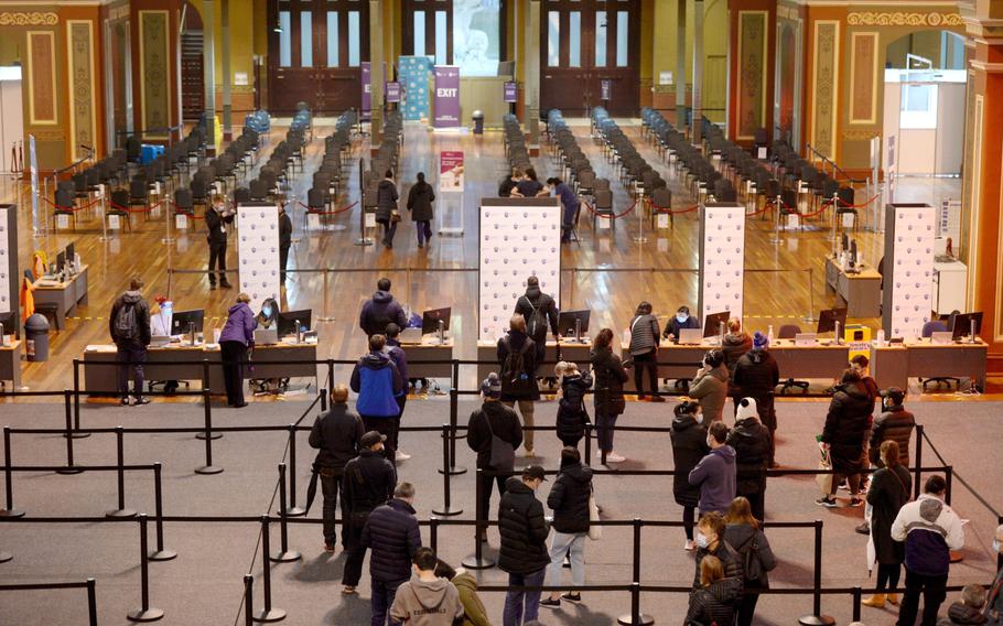 People wait in line to register at a COVID-19 vaccination center set up at the Royal Melbourne Exhibition Centre in Melbourne, Australia, on June 8, 2021. 