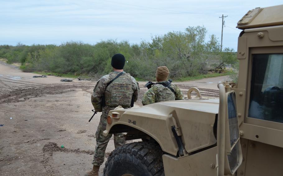 Two Texas National Guard soldiers work an observation post in Hidalgo County near the state’s border with Mexico as part of Operation Lone Star on Jan. 21, 2022. The mission began in March with 500 troops and has surged to about 10,000 in the last three months.