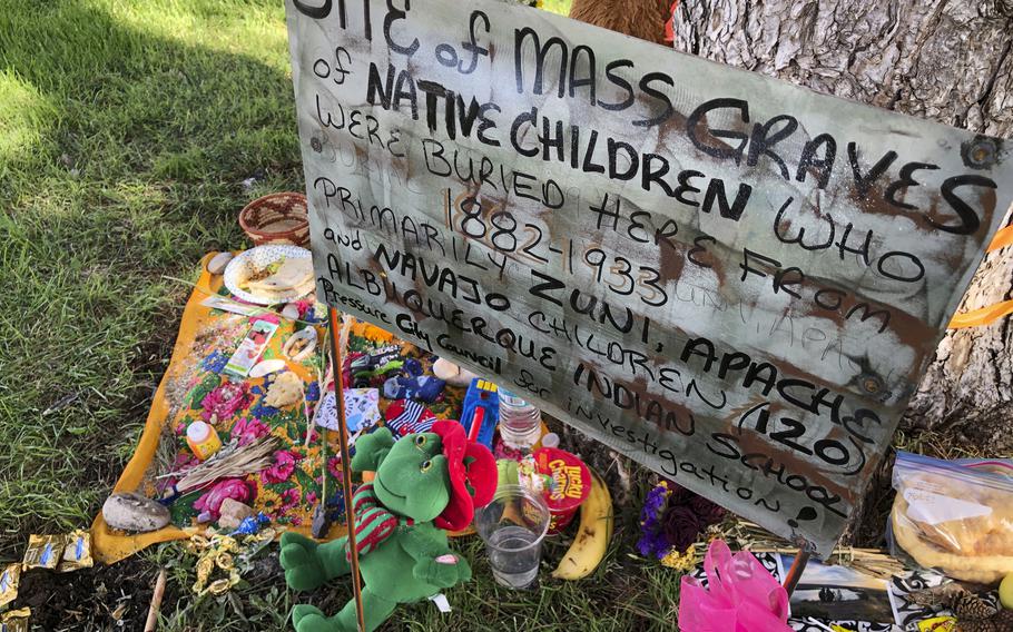 A makeshift memorial for the dozens of Indigenous children who died more than a century ago while attending a boarding school that was once located nearby is displayed under a tree at a public park in Albuquerque, N.M., on  July 1, 2021. 