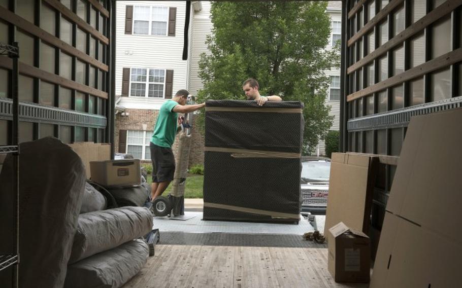 Movers pack household goods at a U.S. base.