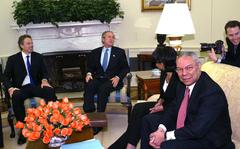 Secretary of State Colin Powell is shown seated at right on April 16, 2004, in the Oval Office of the White House as British Prime Minister Tony Blair, from left, and President George W. Bush joke with photographers. National security adviser Condoleezza Rice is seated at Powell's right. 