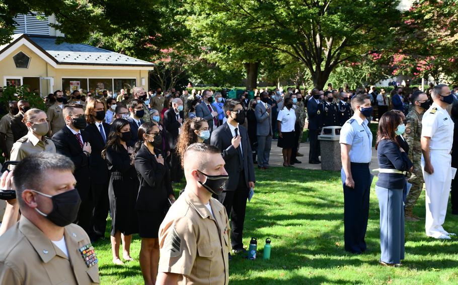 Pentagon employees stand for the national anthem before the 9/11 observance ceremony at the Defense Department’s headquarters on Sept. 10, 2021.