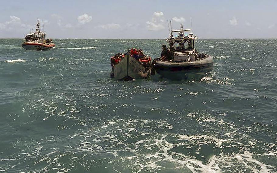 U.S. Coast Guard crews come up to a migrant boat off the Lower Keys on Wednesday, April 5, 2023. 