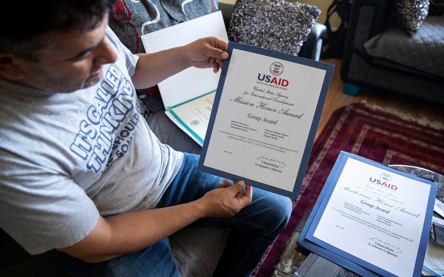 Sadiq Sadeed shows some of the awards he received from USAID, the development agency, at his home in the Mayfair section of Philadelphia. He was translator at USAID in the U.S. Embassy in Kabul, Afghanistan.