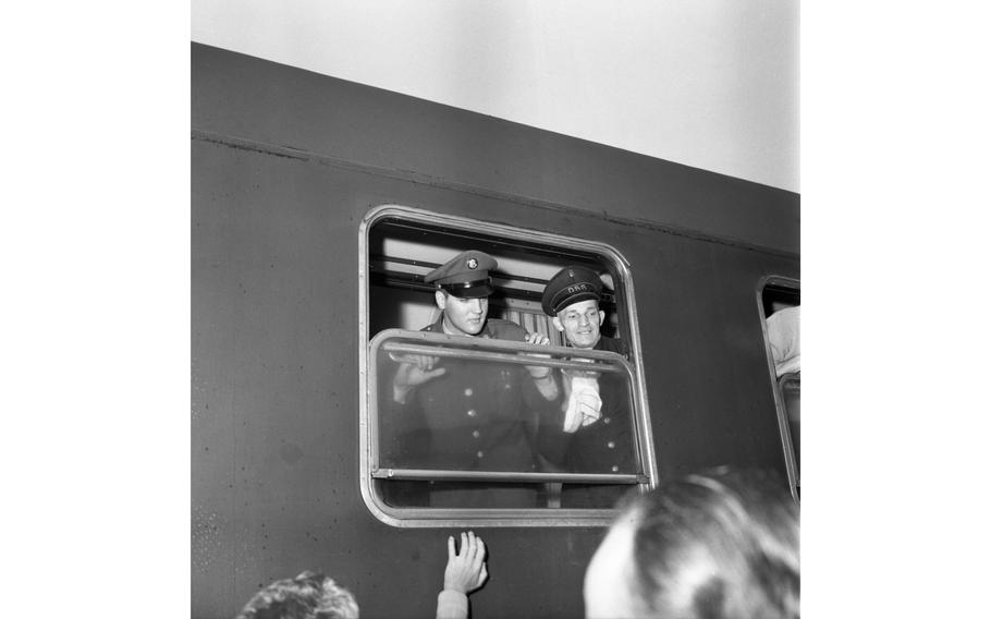 Pvt. Elvis Presley looks from a troop train window as he waits for the train to depart from Bremerhaven, Germany. The singer just arrived in Germany to begin his military service.