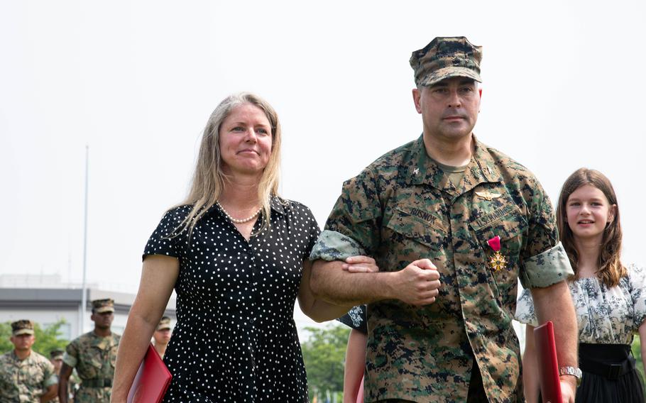 Col. Richard Rusnok escorts his wife back to her seat.