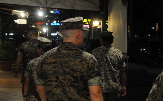 U.S. Marines patrol American Village bars in Chatan, Okinawa, Aug. 2, 2024.
