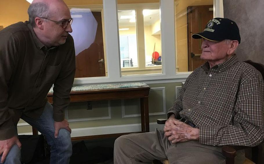 Photographer Jeffrey Rease, left, chats with World War II veteran Russell Brakefield during a portrait session. Brakefield, 93, died on July 2, 2021. 
