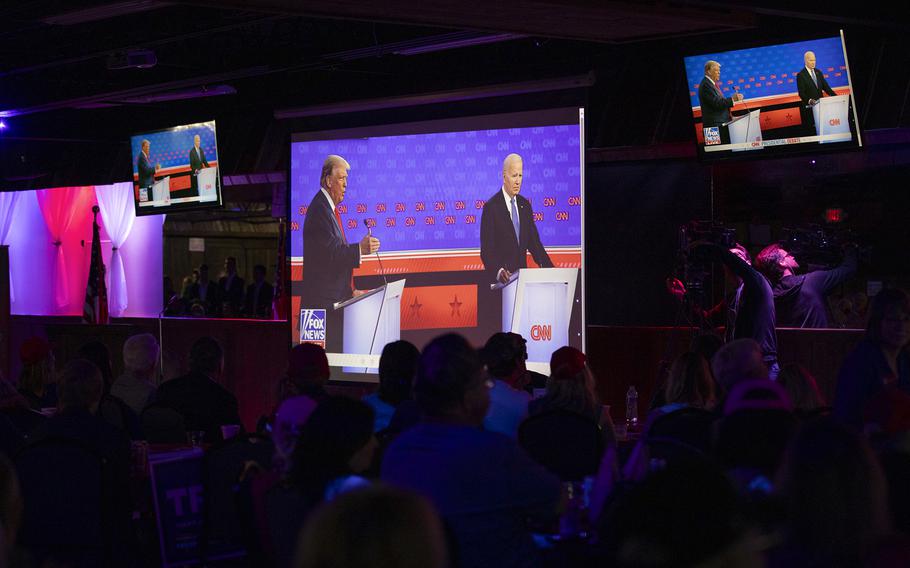 People gather to watch the CNN Presidential Debate between Biden and Trump at Adventure Outdoors in Smyrna, Ga.