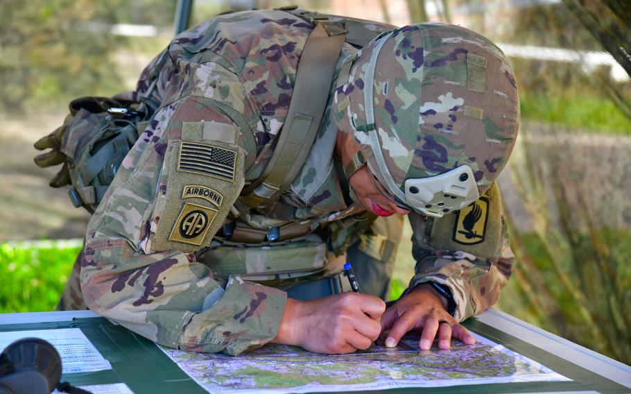 A paratrooper assigned to the U.S. Army’s 173rd Airborne Brigade plots a point on a map for a land navigation event during the weeklong Expert Infantryman Badge, Expert Soldier Badge and Expert Field Medical Badge training at Caserma Del Din, Vicenza, Italy, Oct. 28, 2022. 