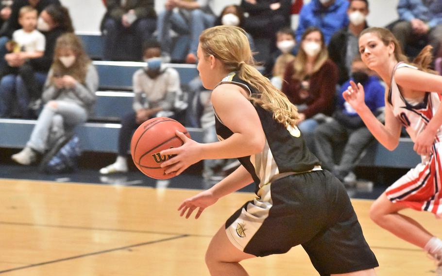 Vicenza freshman guard Mackenzie Blue is off to the races after coming up with a steal in the Cougars’ 34-9 victory over the Aviano Saints on Friday, Feb. 4, 2022, while Aviano’s McKinley Carroll tries to catch up.