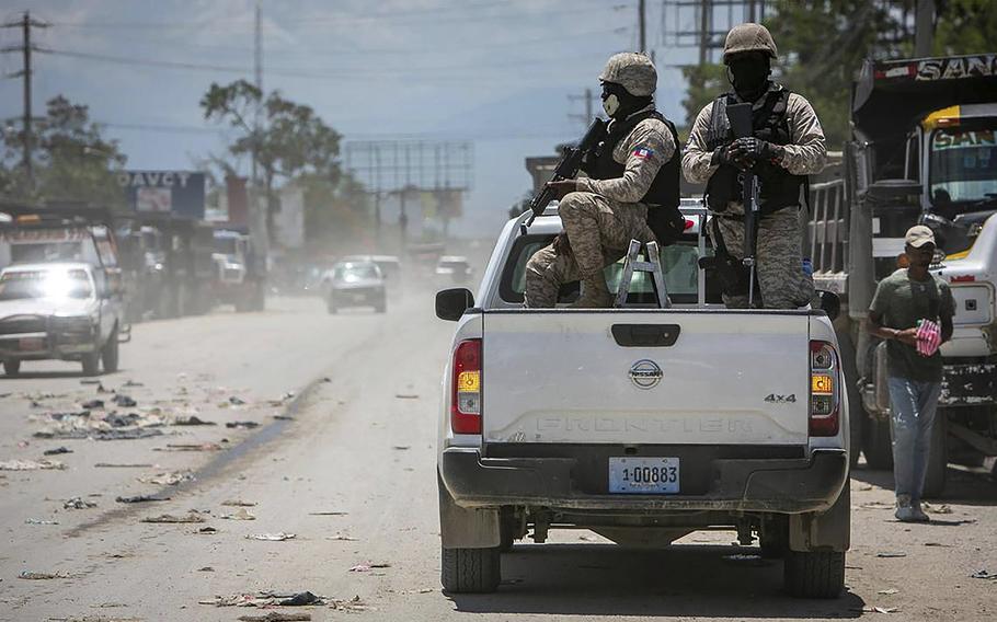 Haiti police on patrol keep their eyes on traffic during a stop at a police checkpoint in Tabarre, near the U.S. Embassy, just east of metropolitan Port-au-Prince.