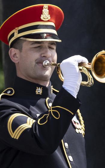 Sgt. 1st Class Kevin Paul of the U.S. Army Band plays Taps during the 20th anniversary celebration of the National World War II Memorial in Washington, D.C., May 25, 2024.