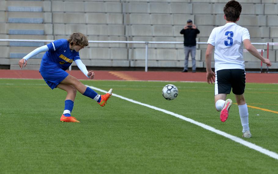 Sigonella’s Mikołaj Czernielewski scores in a Division III semifinal against Brussels at the DODEA-Europe soccer finals in Kaiserslautern, Germany, May 17, 2023. At right is Brussels’ Grant Roher. Sigonella won 6-0 and will face Ansbach in Thursday’s championship game.