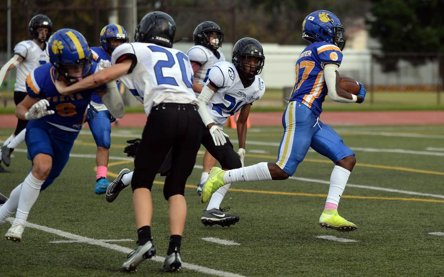 Yokota's A.J. Webster breaks into the clear ahead of Osan's Jamaryeon Price for the game-winning touchdown.