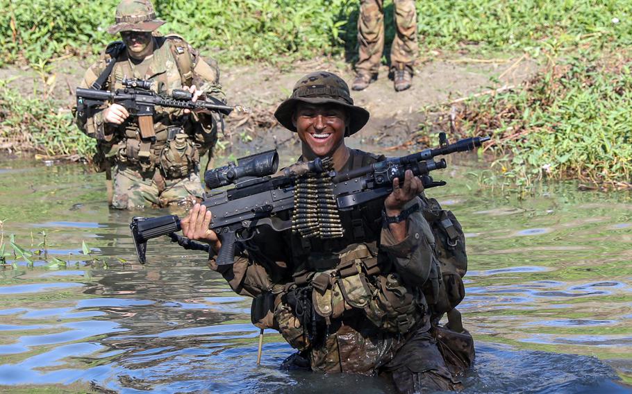 U.S. soldiers cross a creek on Fort Magsaysay during a Salaknib drill in the Philippines, March 23, 2022. 