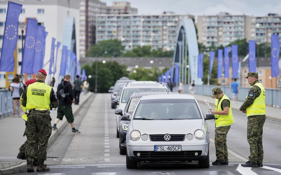 Polish border police check vehicles.