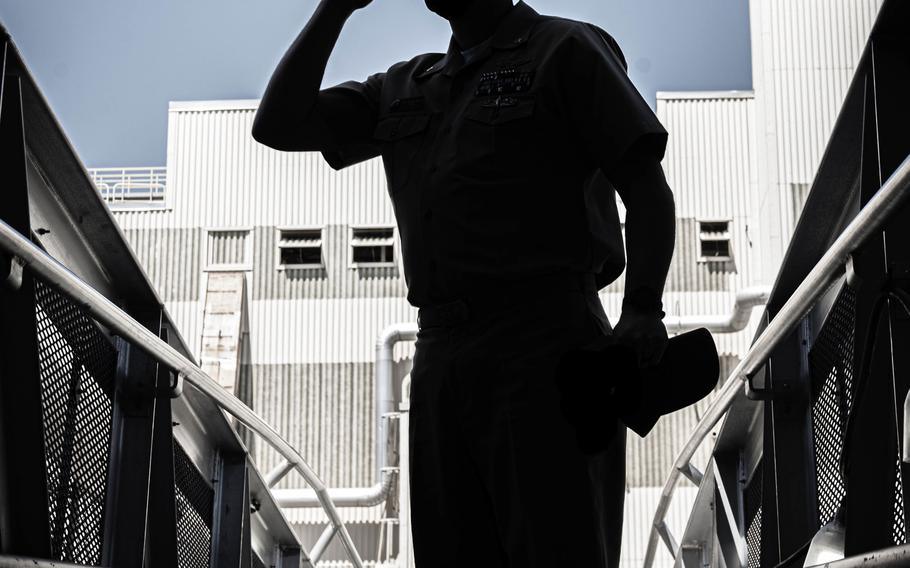 A sailor leaves the aircraft carrier USS George H.W. Bush on April 16, 2021. The Naval Discharge Review Board will review "bad paper" discharges of service members with records of mental health conditions.