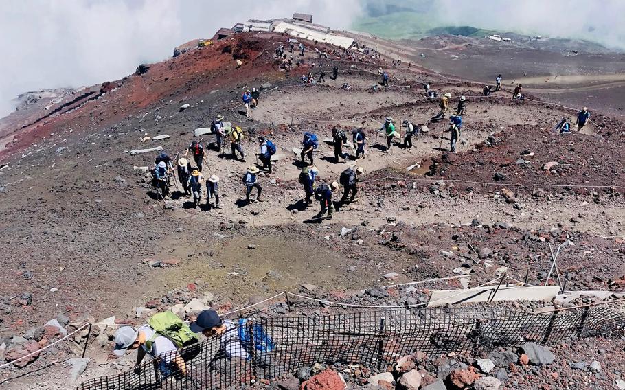 Hikers thread their way along the Yoshida Trail on Mount Fuji, Japan, in August 2019.